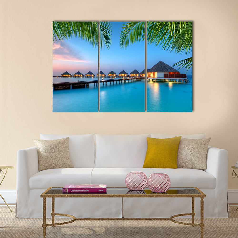 Water Villas on Maldives Resort Canvas Wall Art in green and blue, 3 panel horizontal set hung on a wall