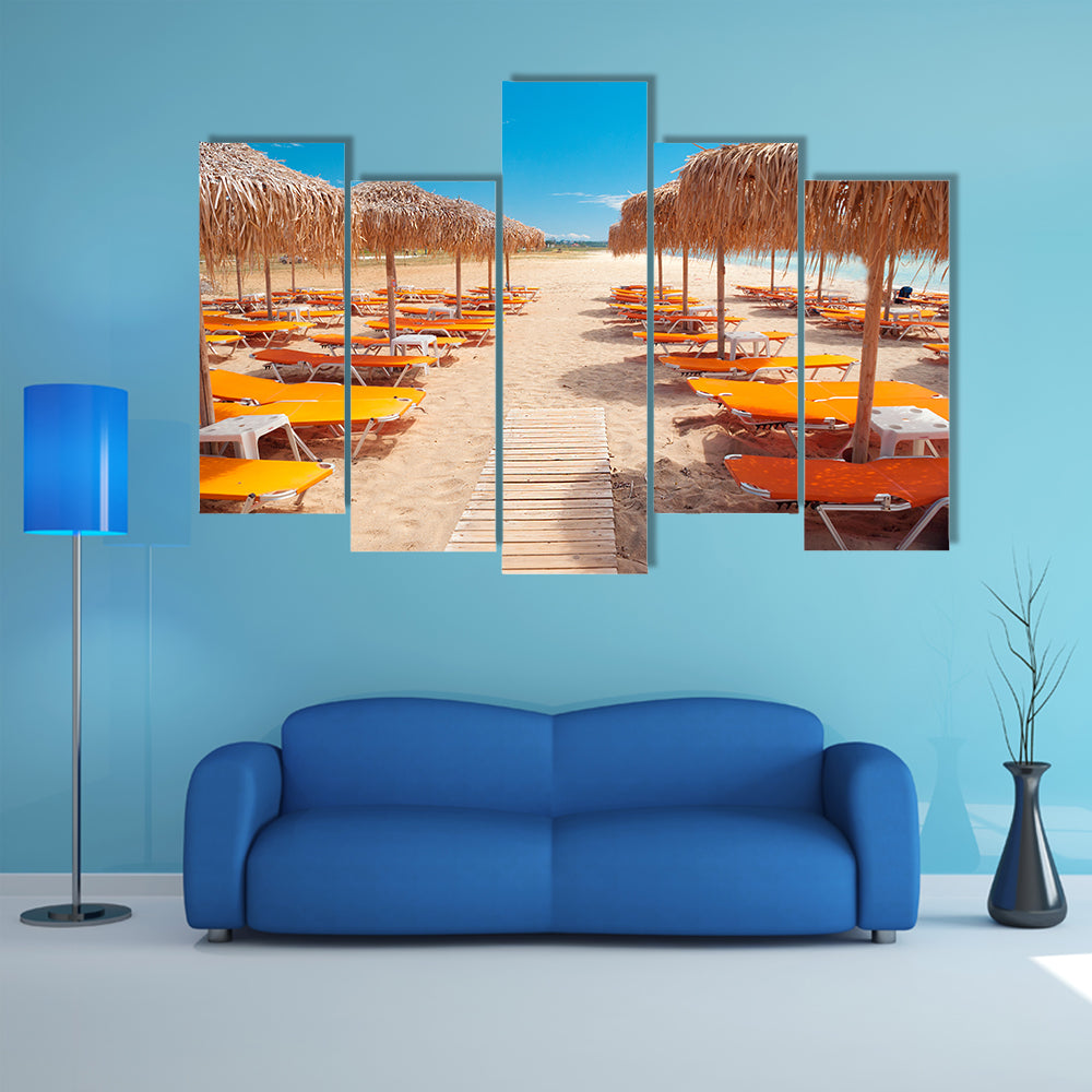 Greek Beach with Wooden Walkway and Orange Loungers Canvas Wall Art