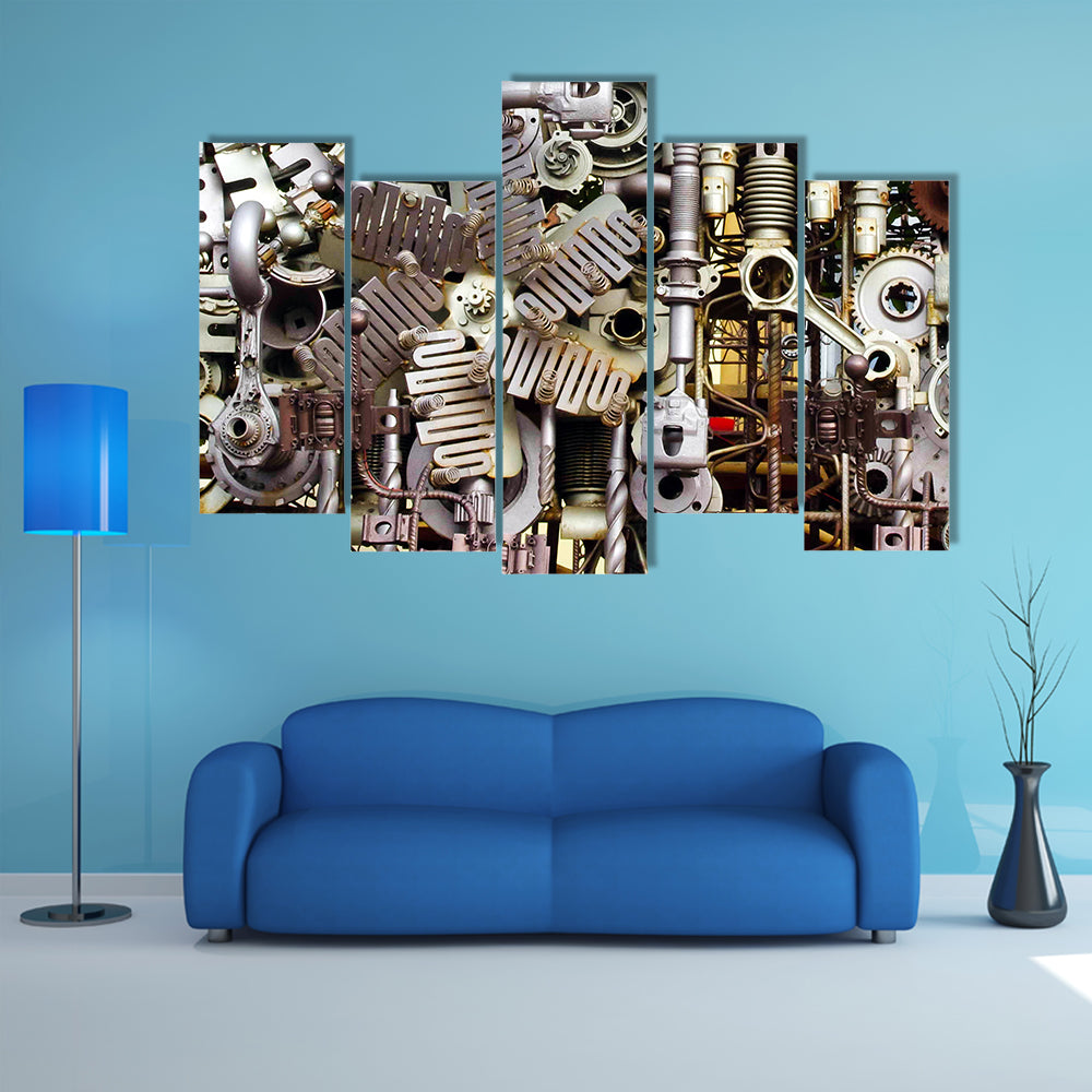 Assembled Metal Machine Parts Canvas Wall Art in gray and silver, 5 panel Pop layout hung on a wall
