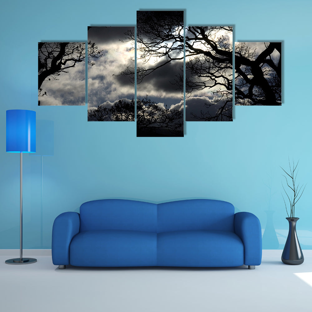 Silhouetted Trees Under Storm Clouds Canvas Wall Art