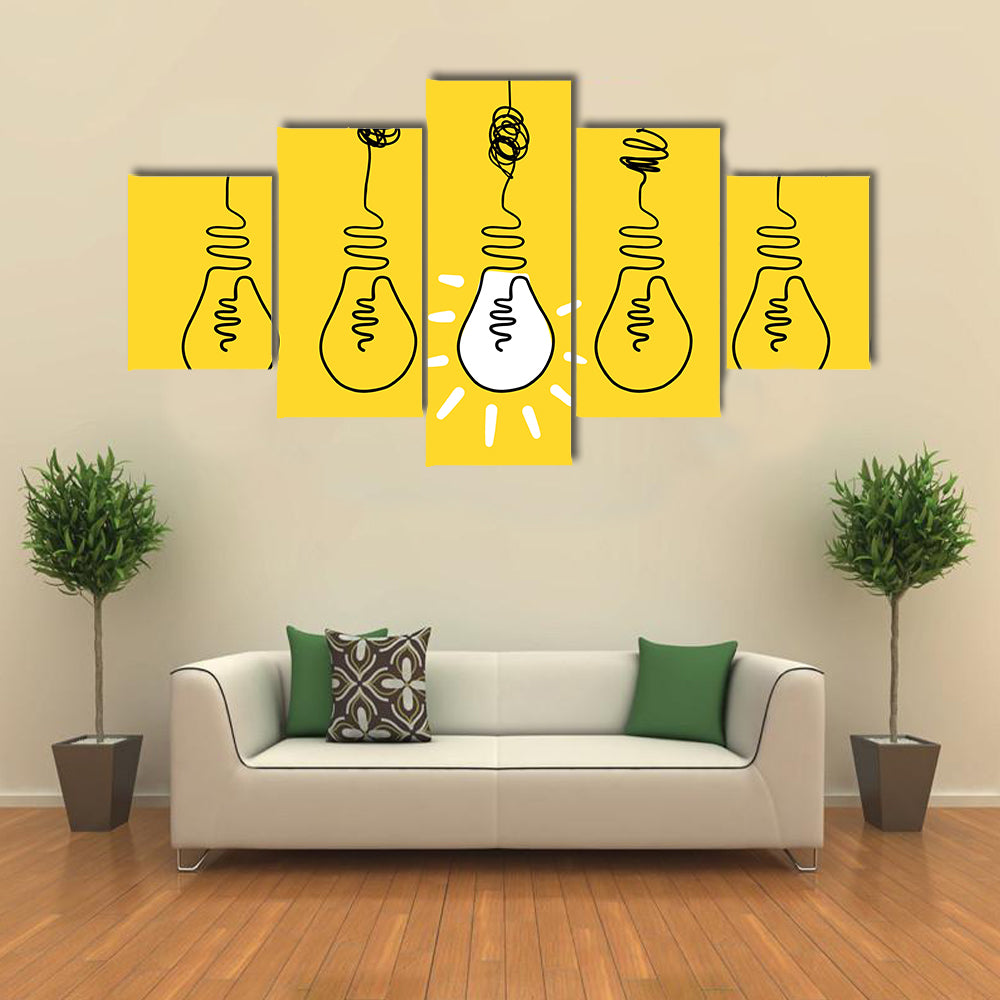 Four Lightbulbs Technology Concept Canvas Wall Art in black, white and yellow, 5 panel Star layout hung on a wall