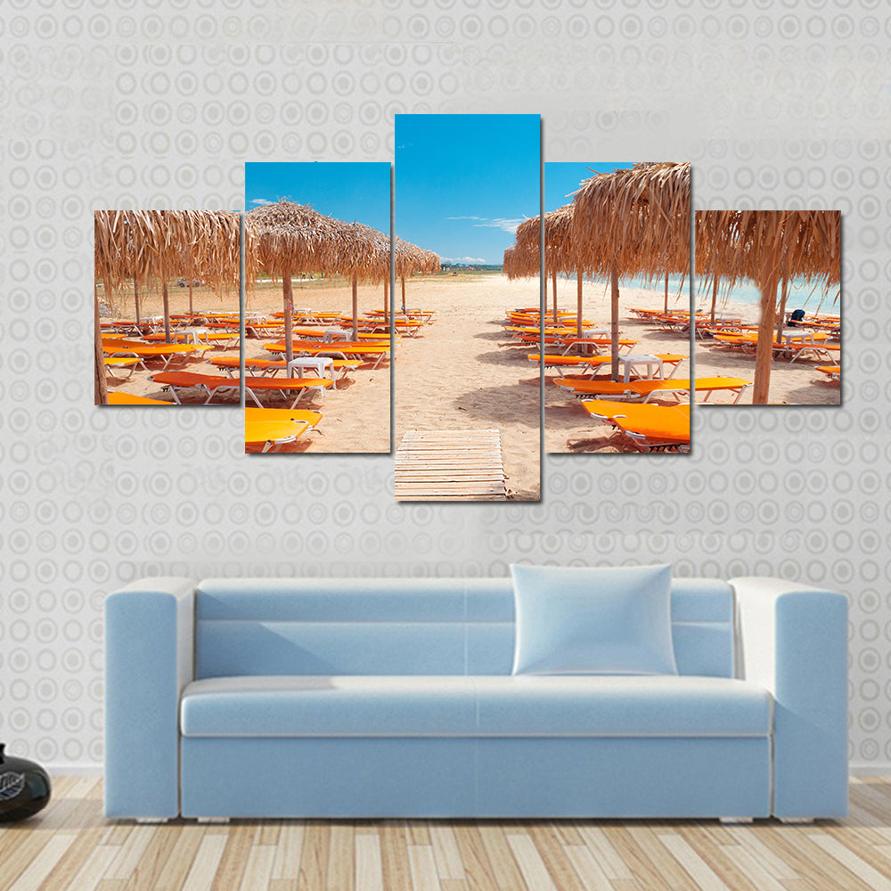 Greek Beach with Wooden Walkway and Orange Loungers Canvas Wall Art