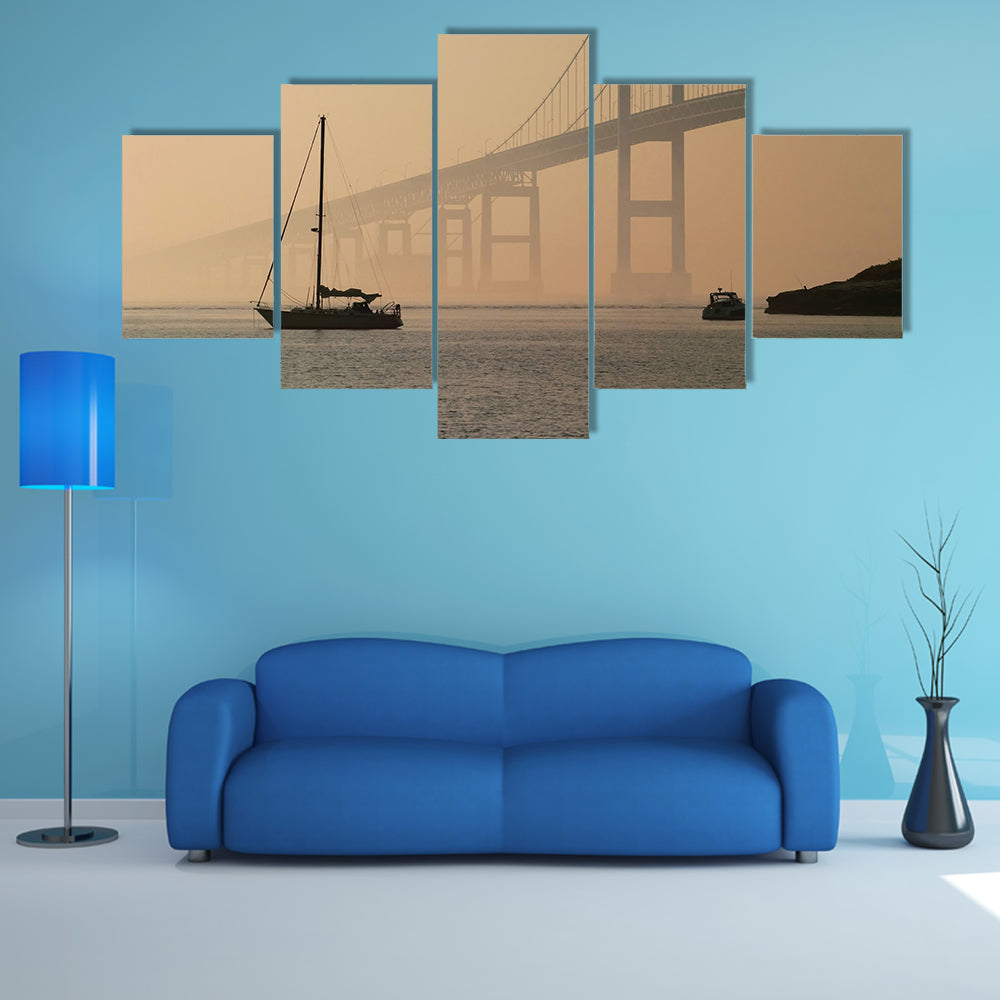 Hazy Suspension Bridge with Sailboat Canvas Wall Art