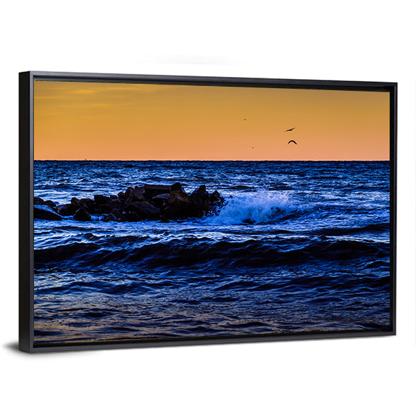 Blue Ocean Waves at Sunset Canvas Wall Art in orange, blue and navy, framed canvas, product view on a white background