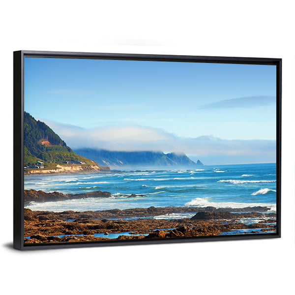 Rocky Shoreline with Crashing Waves and Misty Coastal Hills Canvas Wall Art