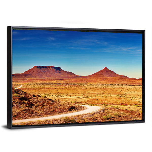 Winding Desert Road to Distant Peaks Canvas Wall Art in brown, orange and blue, framed canvas, product view on a white background