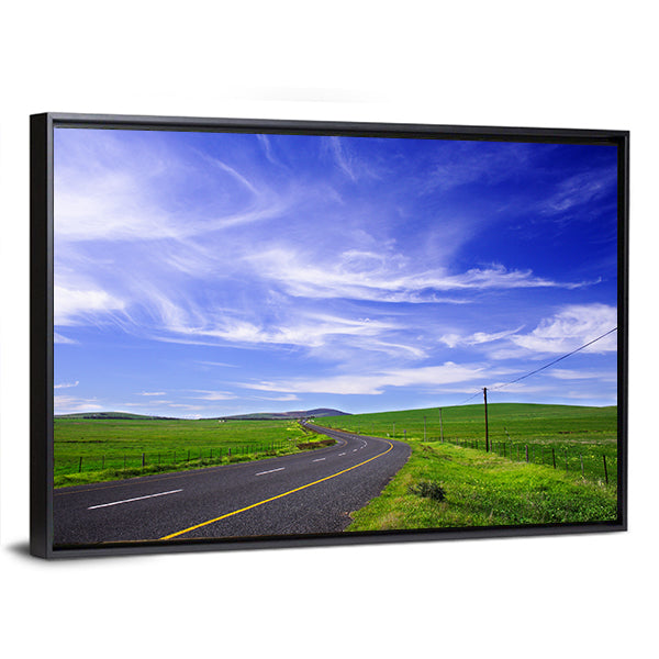 Winding Road Through Green Fields Canvas Wall Art in black, green and blue, framed canvas, product view on a white background