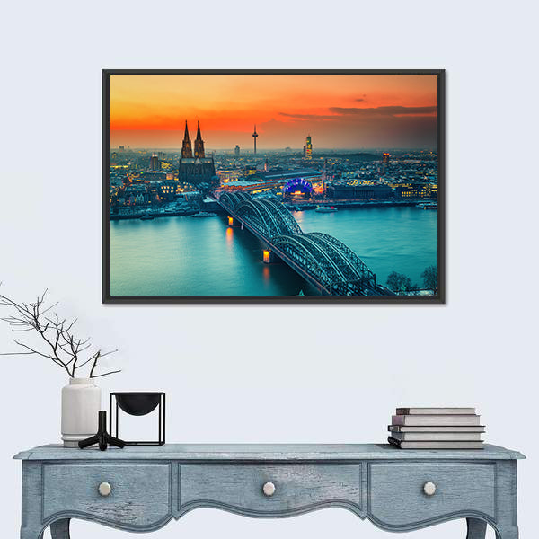 Cologne Cathedral And Hohenzollern Bridge At Night In Germany Canvas Wall Art in gray, orange and yellow, framed canvas shown in a room