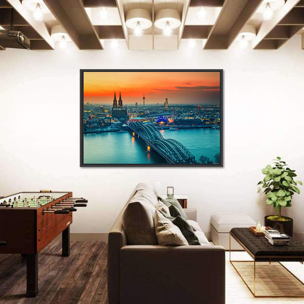 Cologne Cathedral And Hohenzollern Bridge At Night In Germany Canvas Wall Art in gray, orange and yellow, framed canvas shown in a room
