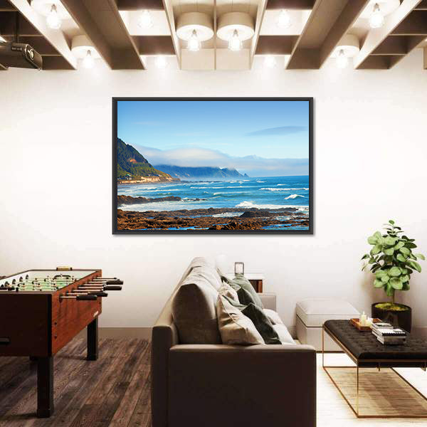 Rocky Shoreline with Crashing Waves and Misty Coastal Hills Canvas Wall Art