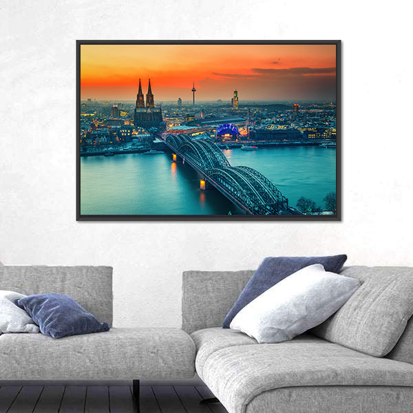 Cologne Cathedral And Hohenzollern Bridge At Night In Germany Canvas Wall Art in gray, orange and yellow, framed canvas shown in a room