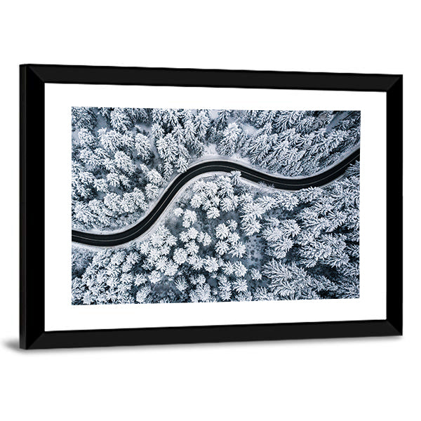 Curvy Windy Road In Snow Covered Forest Canvas Wall Art in black, white and gray, framed print, product view on a white background