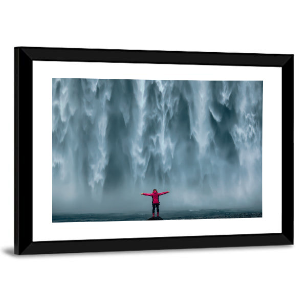 Girl Against Skogafoss Waterfall At South Iceland Canvas Wall Art in white, gray and blue, framed print, product view on a white background