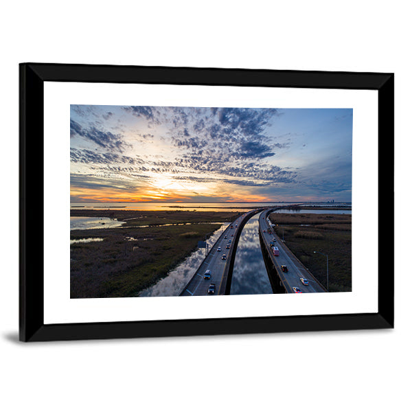 Sunset Over Highway Bridge Canvas Wall Art in orange, yellow and blue, framed print, product view on a white background