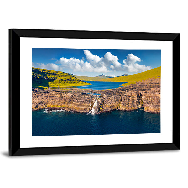 Bosdalafossur Waterfall And Sorvagsvatn Lake In Denmark Canvas Wall Art in brown, green and blue, framed print, product view on a white background
