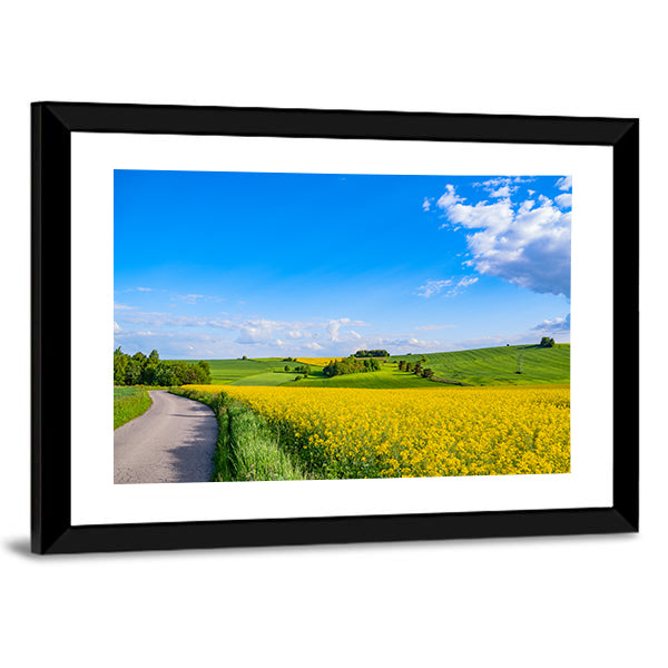 Oilseed field In Italian Countryside Canvas Wall Art in yellow, green and blue, framed print, product view on a white background