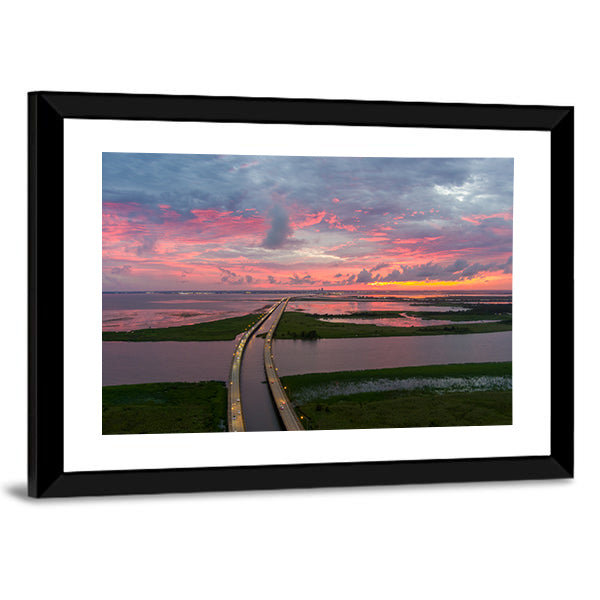 Sunset Over Coastal Bridge Canvas Wall Art in orange, blue and pink, framed print, product view on a white background