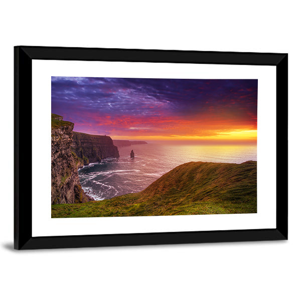 Sunset at the Cliffs of Moher Canvas Wall Art in orange, green and purple, framed print, product view on a white background