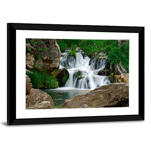 Small Forest Waterfall Canvas Wall Art in white, brown and green, framed print, product view on a white background