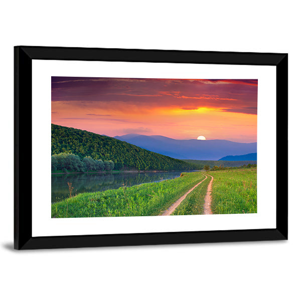 Sunset Meadow with River and Dirt Road Canvas Wall Art in orange, green and purple, framed print, product view on a white background