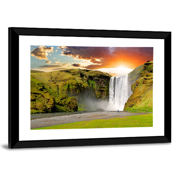 Skogafoss Waterfall At Sunset In Iceland Canvas Wall Art in orange, yellow and green, framed print, product view on a white background