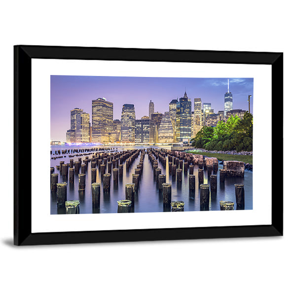 New York City Skyline At Night Canvas Wall Art in yellow, blue and purple, framed print, product view on a white background