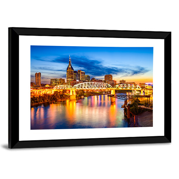 Nashville Skyline with Pedestrian Bridge at Dusk Canvas Wall Art in orange, yellow and blue, framed print, product view on a white background
