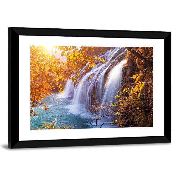 Autumn Waterfall with Sunlit Foliage Canvas Wall Art in orange, yellow and blue, framed print, product view on a white background