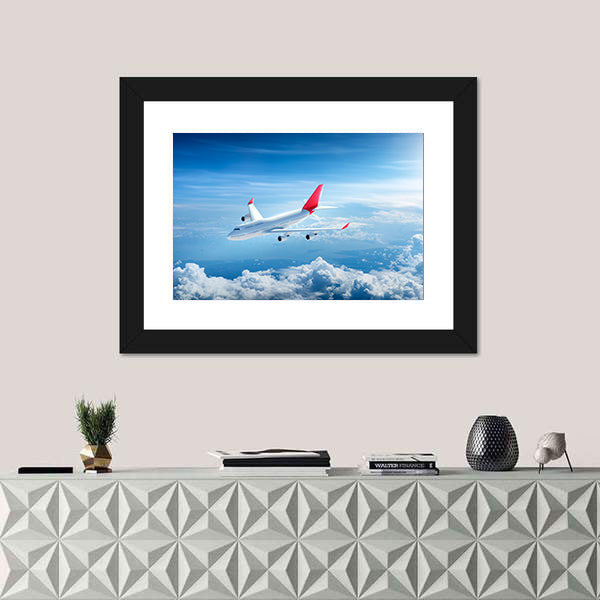 Airplane Flying Above Clouds Canvas Wall Art