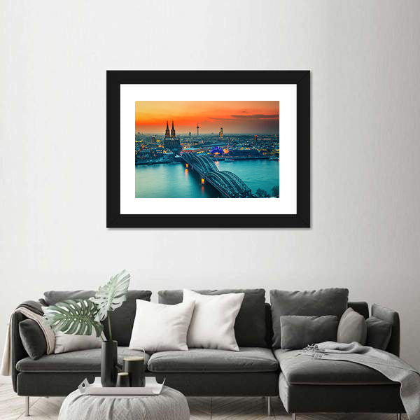Cologne Cathedral And Hohenzollern Bridge At Night In Germany Canvas Wall Art in gray, orange and yellow, framed print shown in a room