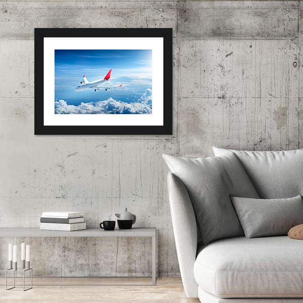 Airplane Flying Above Clouds Canvas Wall Art