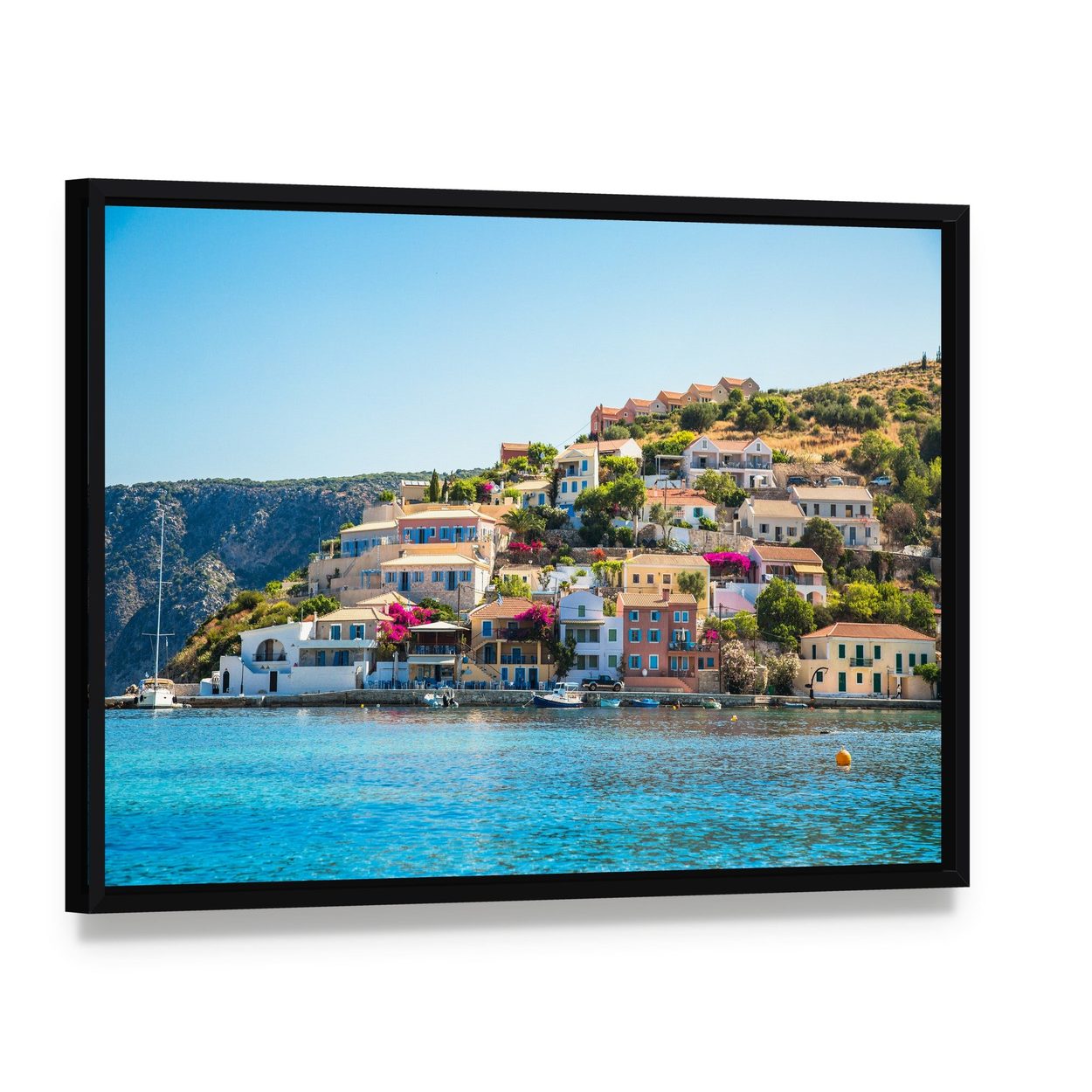 Kefalonia Village by the Sea Canvas Wall Art, framed canvas in a black floater frame, angled product view