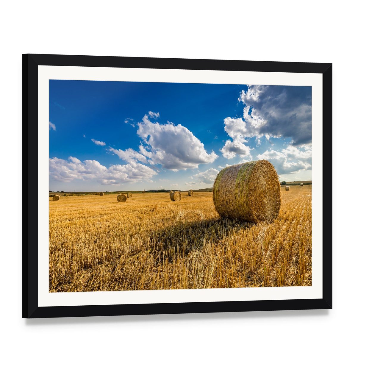 Yellow Hay Bale in a Summer Field Canvas Wall Art, framed print with white mat and black frame, angled product view
