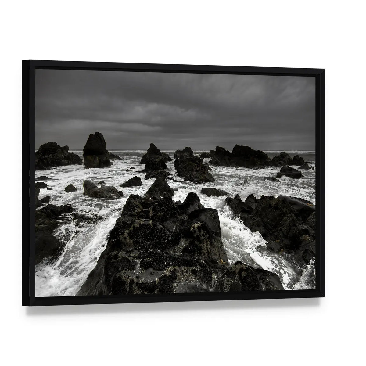 Crashing Waves on Rocky Coastline Canvas Wall Art, framed canvas in a black floater frame, angled product view