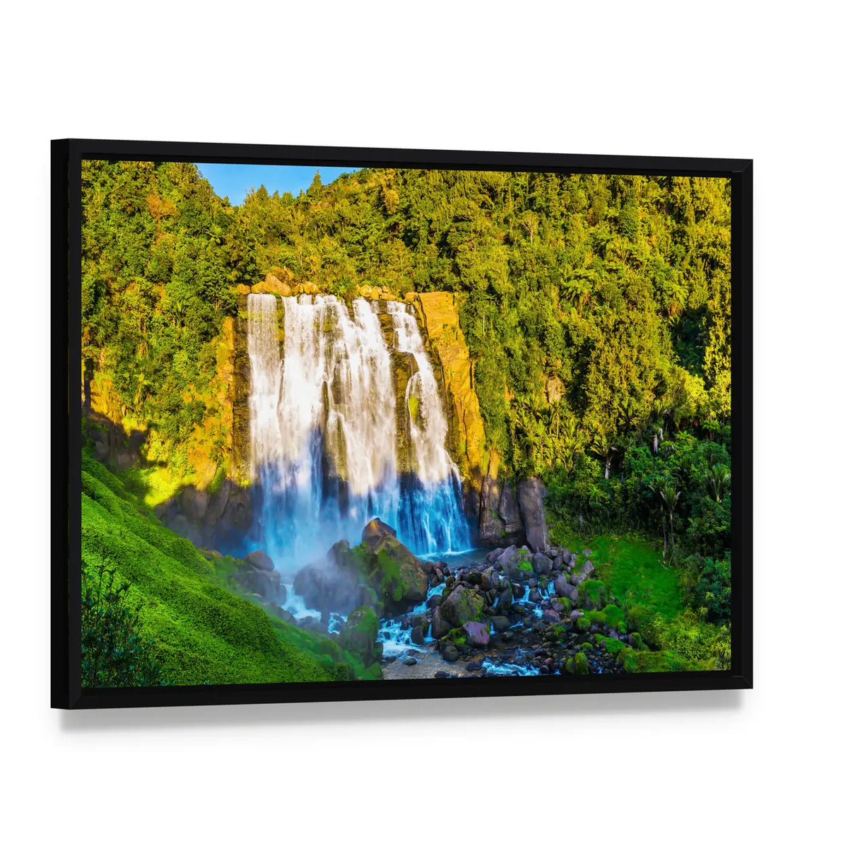 Marokopa Falls Over Forested Rocks Canvas Wall Art, framed canvas in a black floater frame, angled product view