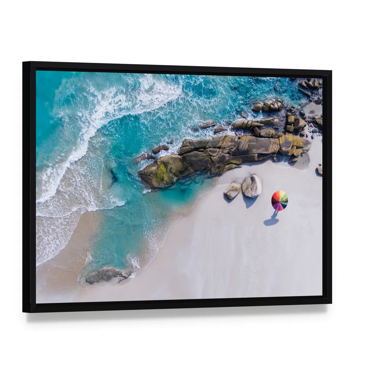Umbrella On The Beach And Foam Of Sea Wave Canvas Wall Art, framed canvas in a black floater frame, angled product view