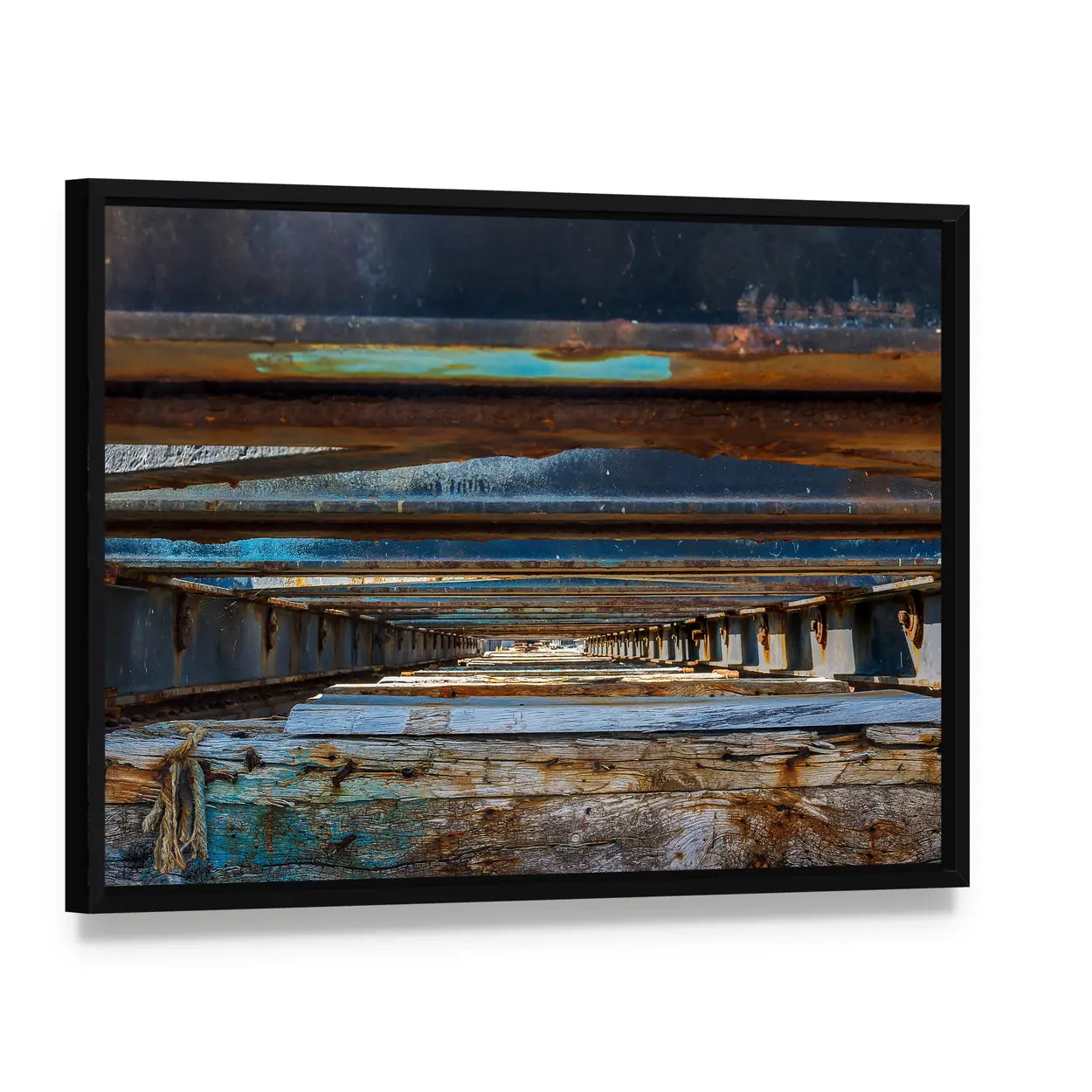 Under Pier Rusted Beams and Weathered Wood Canvas Wall Art, framed canvas in a black floater frame, angled product view