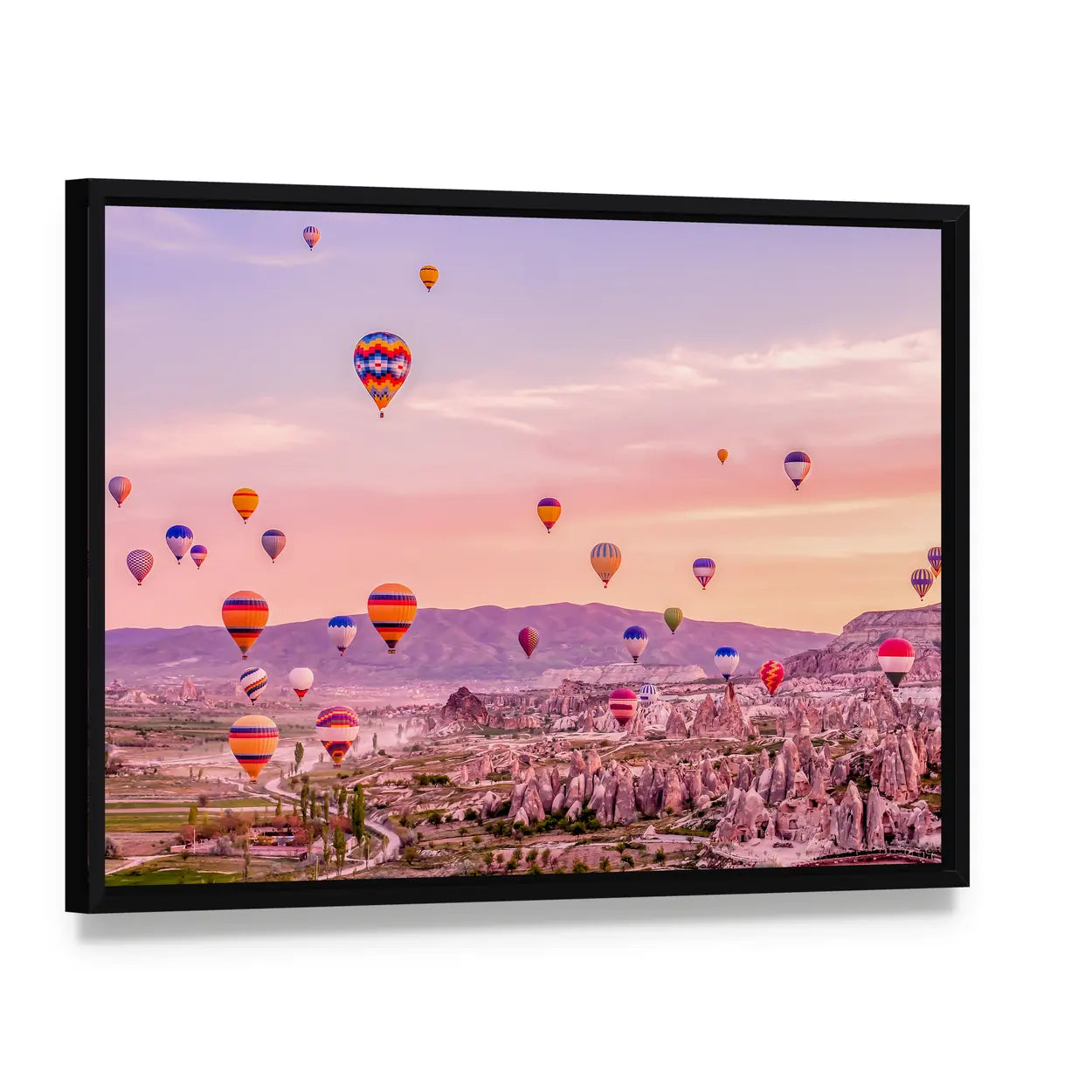 Hot Air balloons Flying Over Rock Landscape At Cappadocia Canvas Wall Art, framed canvas in a black floater frame, angled product view
