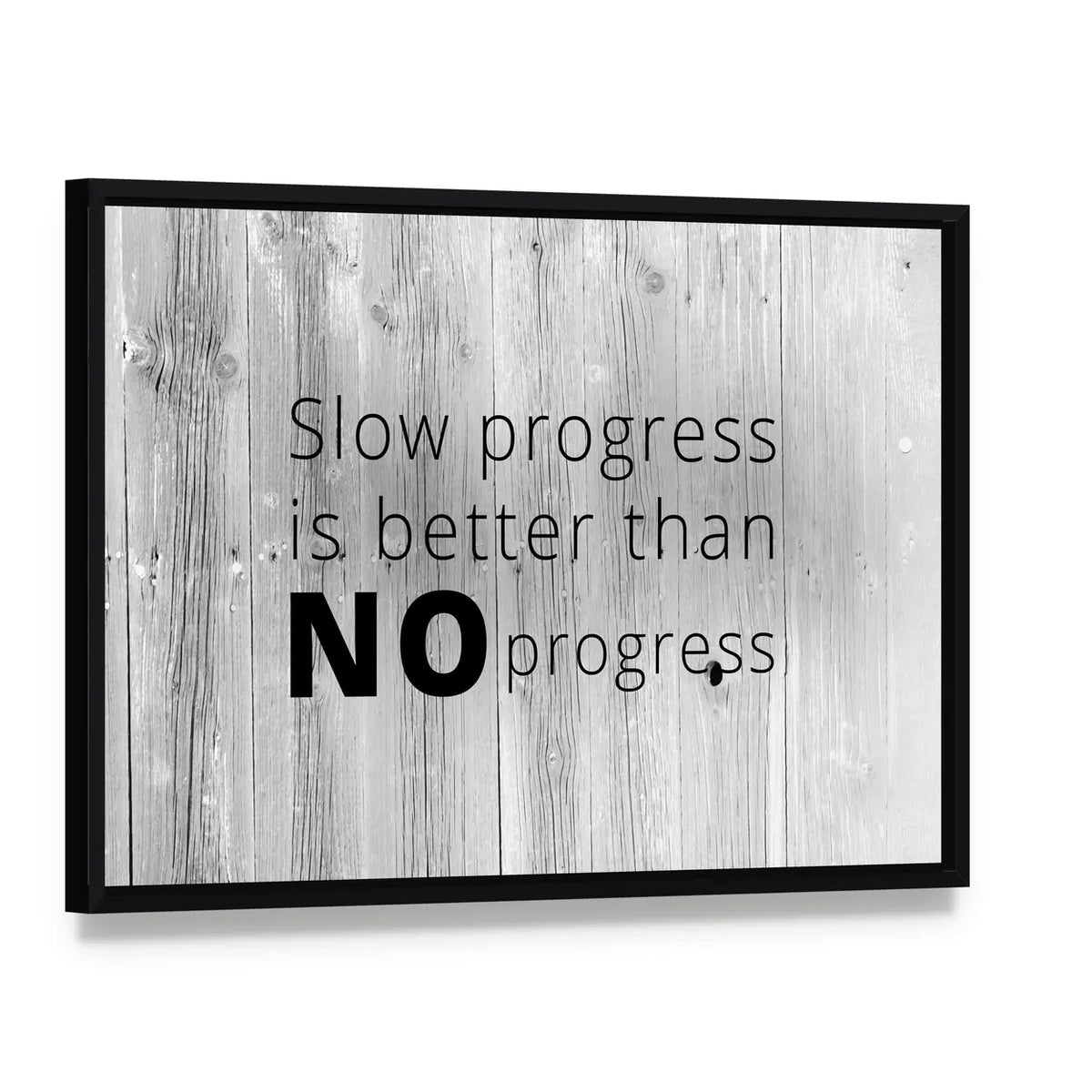 Keep Working Quote on White-washed Wood Canvas Wall Art, framed canvas in a black floater frame, angled product view