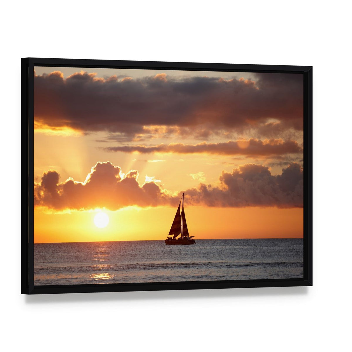 Sailboat at Sunset Over Ocean Canvas Wall Art, framed canvas in a black floater frame, angled product view
