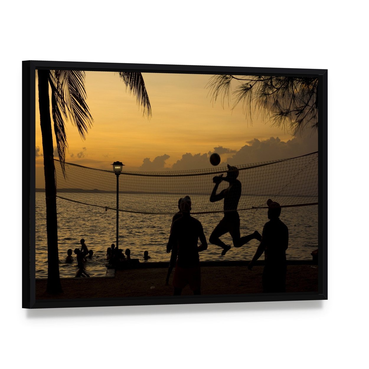 Silhouette of People Playing Beach Volleyball at Sunset Canvas Wall Art, framed canvas in a black floater frame, angled product view