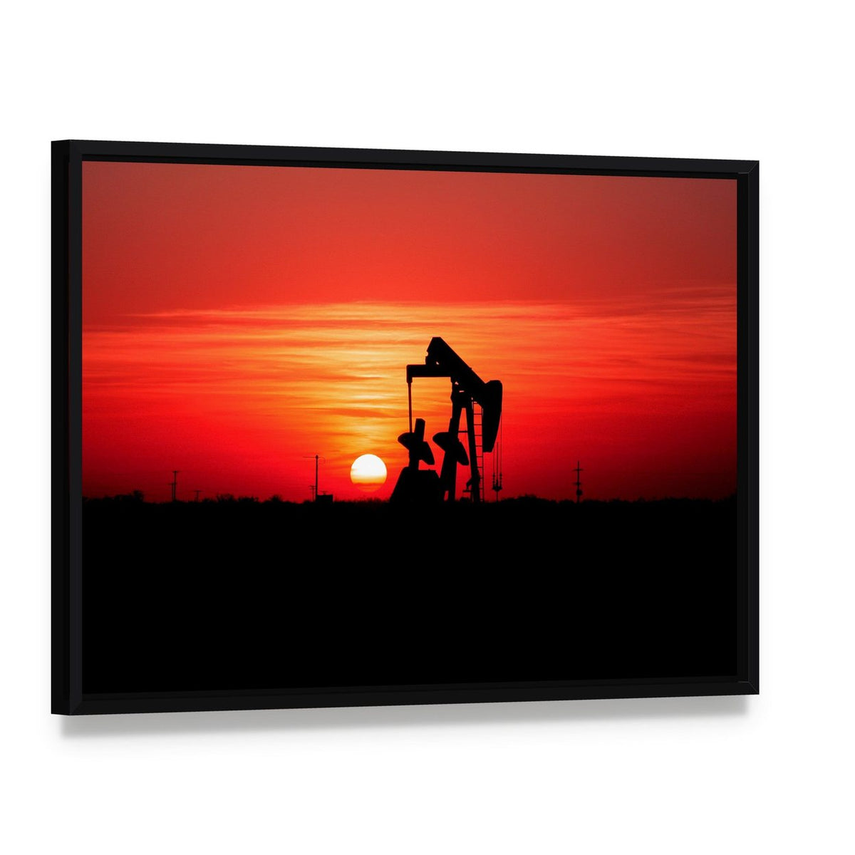 Silhouetted Oil Pump Jack at Sunset Canvas Wall Art, framed canvas in a black floater frame, angled product view