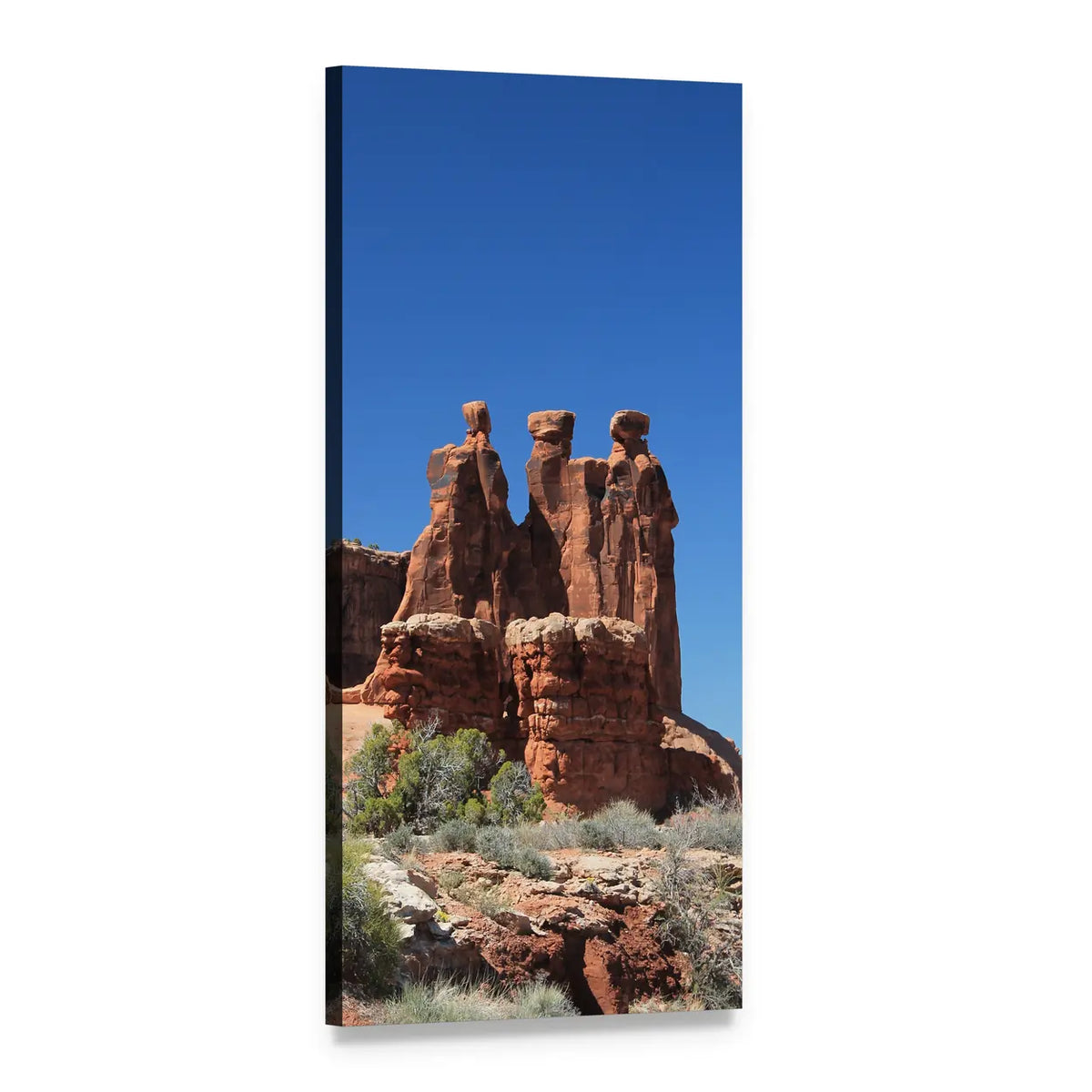 Three Sandstone Pinnacles Against Blue Sky Vertical Canvas Wall Art, 1 panel 1 Vertical layout gallery wrapped canvas set, angled product view