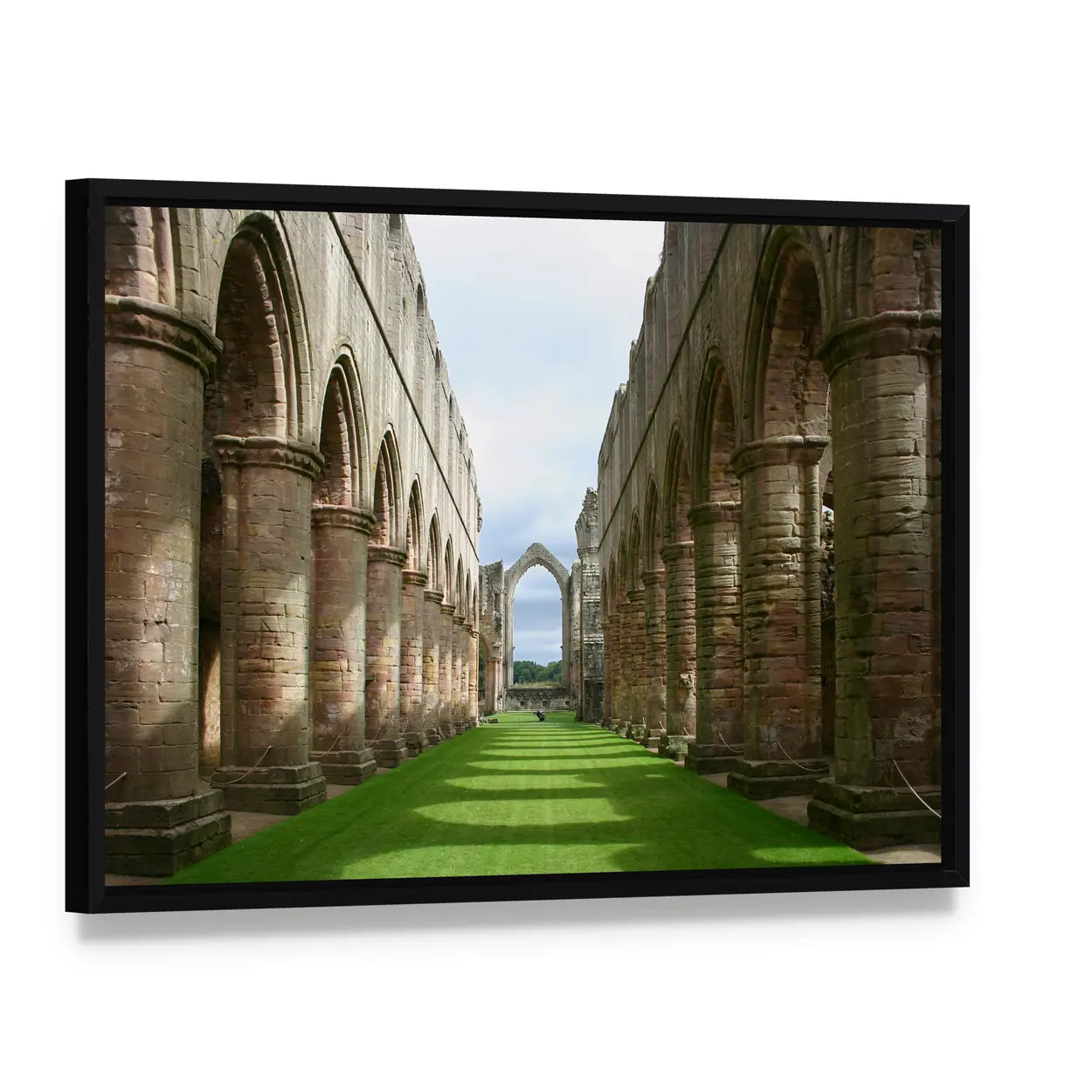 Ruins of Fountains Abbey Canvas Wall Art, framed canvas in a black floater frame, angled product view