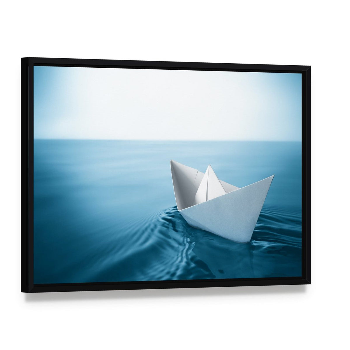 Paper Sailboat in Water Canvas Wall Art, framed canvas in a black floater frame, angled product view