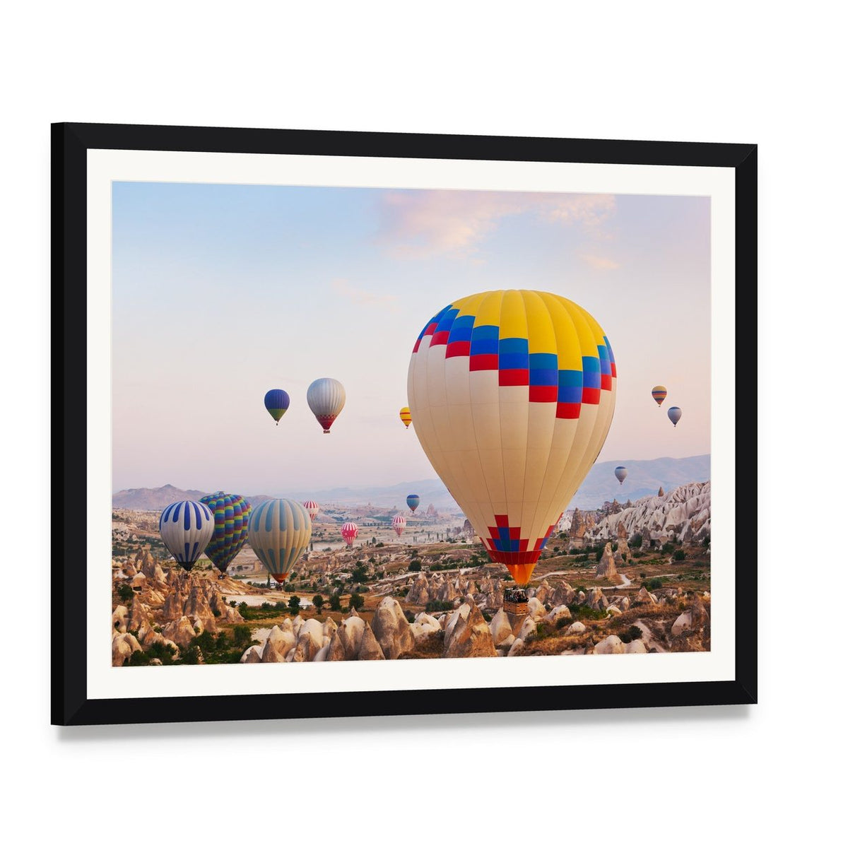 Hot Air Balloons Over Cappadocia Canvas Wall Art, framed print with white mat and black frame, angled product view