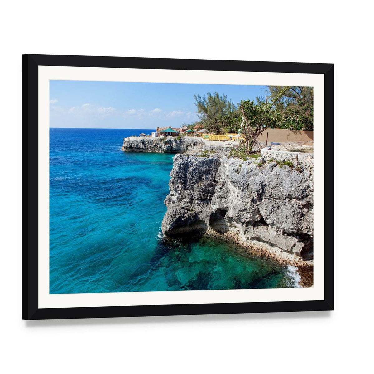 Turquoise Ocean Cliffs with Tropical Vegetation Canvas Wall Art, framed print with white mat and black frame, angled product view