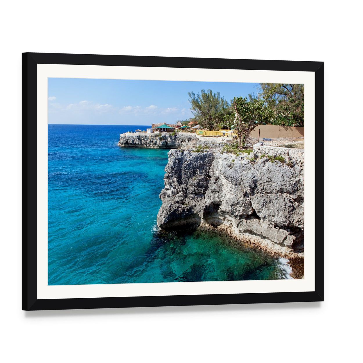 Turquoise Ocean Cliffs with Tropical Vegetation Canvas Wall Art, framed print with white mat and black frame, angled product view