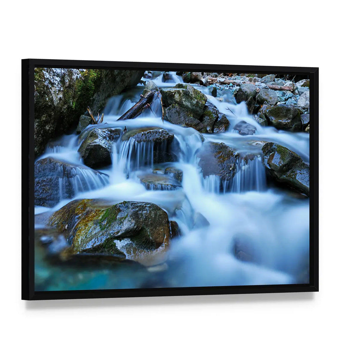 River Through Mossy Stones in Cadore Canvas Wall Art, framed canvas in a black floater frame, angled product view