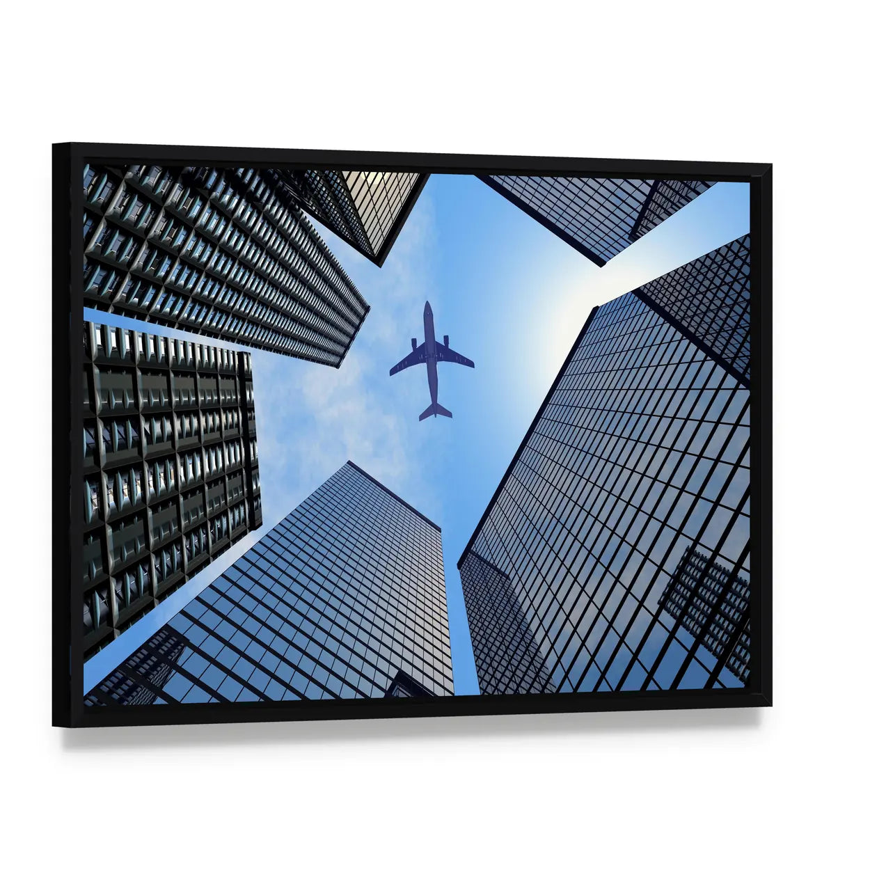 Airplane Above Skyscrapers Canvas Wall Art, framed canvas in a black floater frame, angled product view